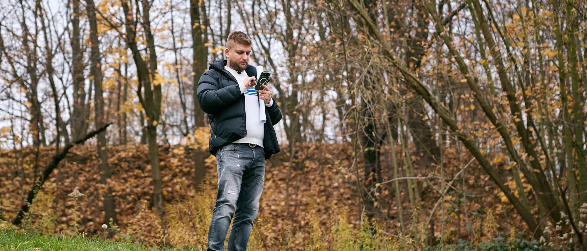 Maxim Ponomarenko with documents on the plot beside a property